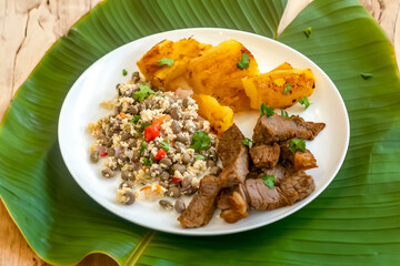 Traditional rustic tropical Brazilian dish, sun-dried beef with green beans, cassava, biquinho pepper. Creative rustic photography