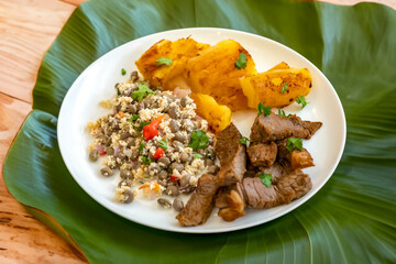 Traditional rustic tropical Brazilian dish, sun-dried beef with green beans, cassava, biquinho pepper. Creative rustic photography