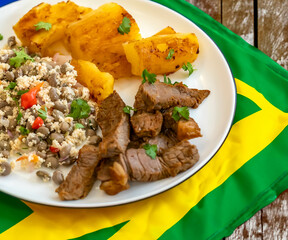 Traditional rustic tropical Brazilian dish, sun-dried beef with green beans, cassava, biquinho...