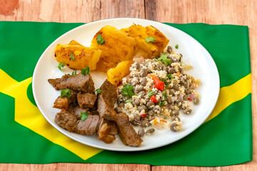 Traditional rustic tropical Brazilian dish, sun-dried beef with green beans, cassava, biquinho...