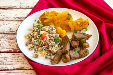 Traditional rustic tropical Brazilian dish, sun-dried beef with green beans, cassava, biquinho pepper. Creative rustic photography