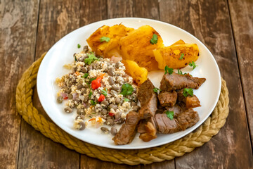 Traditional rustic tropical Brazilian dish, sun-dried beef with green beans, cassava, biquinho pepper. Creative rustic photography