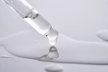 Dropper pipette with delicious serum with drop close-up.