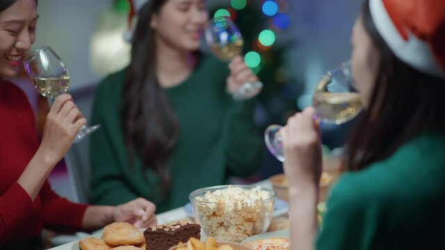 Friends join and celebrate the party with get cheers give a toast by clink glasses eating foods and drinks champagne. Happy and joyful in holiday weekend and festival.