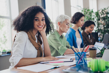 Photo of lovely four businessladies feminist meeting community cheerful smile comfortable startup meeting office room interior