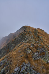 Woman hiker on a rough trail in the mountains