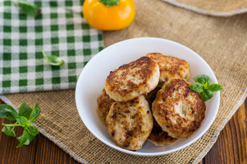 fried chicken cutlets in a bowl on a wooden table