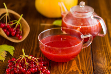 tea from ripe red viburnum on a wooden table