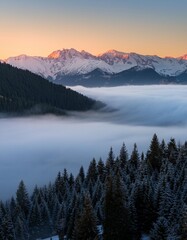 Obraz premium Rolling Fog Over a Quiet Mountain Valley, Surrounded by Snow-Capped Peaks and Dense Pine Forests, Creating a Mysterious Atmosphere as the First Light of Dawn Breaks