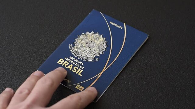 International passport of a citizen of Brazil on a dark concrete background, international travel