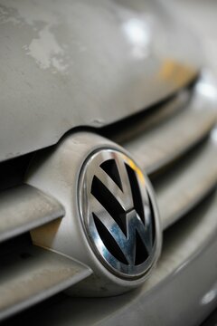 Front logo of a parked silver colored Volkswagen Golf Plus 2006 in a parking lot