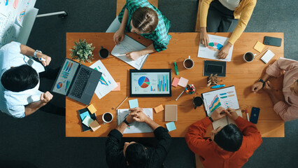 Top view of skilled business people sharing idea about startup project while standing at...