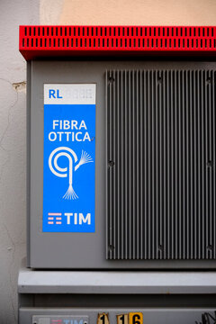 Gray metal box containing tim fiber optic cables, fixed on a cracked wall, ensuring high-speed internet connectivity