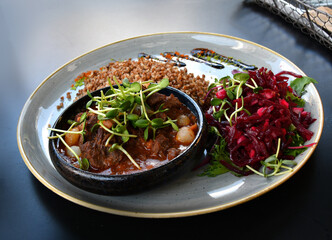 Beef goulash with buckwheat served in restaurant