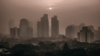 Mist rolls over a modern cityscape with warm sunlight casting sepia tones on buildings and natural elements in a tranquil cinematic setting.