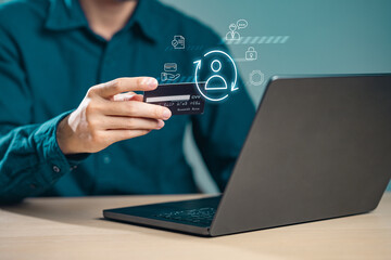 ecommerce, internet, communication, purchase, online shopping, exchange, credit, e-commerce, contact, financial. A man is holding a credit card in front of a laptop. Concept of online shopping.