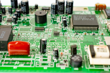 Close-up of a circuit board with microcircuits from an electrical appliance or computer. Selective focus.