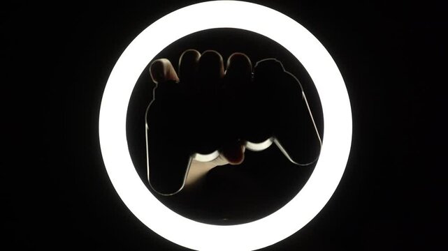female hands hold a gamepad on a black background. joystick controller for gaming platform close-up. Esports and cybersports concept