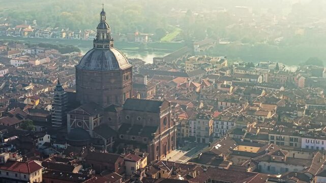 Aerial perspective of Pavia, Italy. Ancient buildings and the magnificent Duomo are prominently featured against soft, hazy background