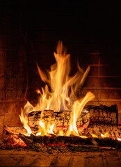 Fire flames, wood burning in fireplace. Warm home in winter, heat. Christmas holiday