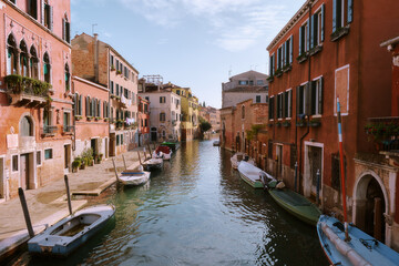 Venetian canal with vibrant boats and charming architecture