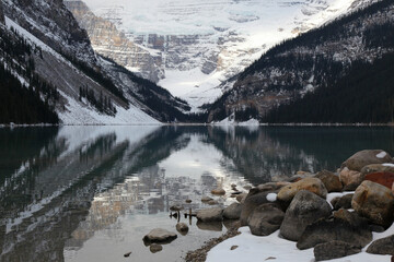 Lake Louise reflecting the rocky mountains with snow in autumn, Banff national park, Alberta, Canada, North America