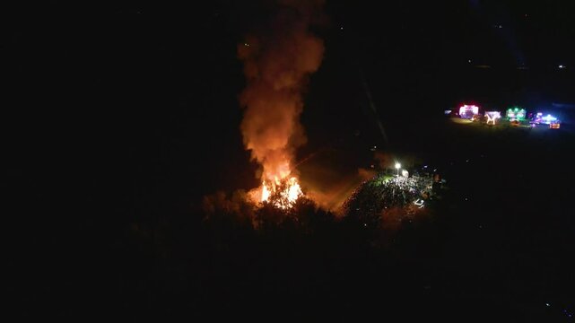 crowd bonfire fair tain scotland vibrant flames smoke enhance festive families gather to share joyful forward aerial view atmosphere enjoyment celebration gathering community 