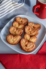 puff pastry in the shape of a heart or palm. dessert with chocolate