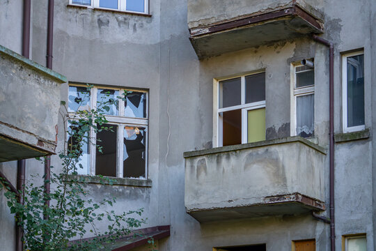 view of abandoned buildings disfiguring the city center. tenement house after a fire, broken windows.