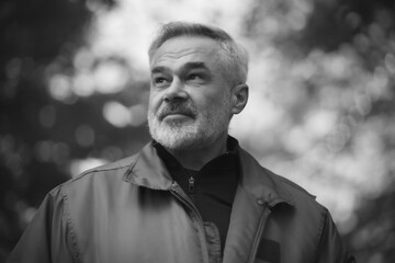 Portrait of mature manwalking in the park, closeup 