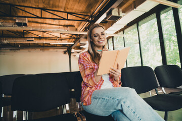Fototapeta premium Photo of young blonde lady write notebook take notes dressed plaid shirt comfortable daylight lecture listener auditorium room interior