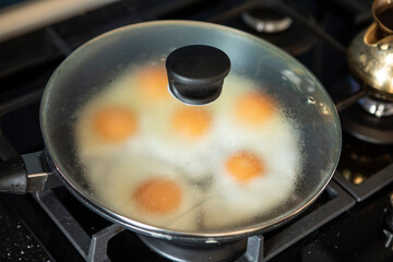 Top view of frying eggs in a frying pan