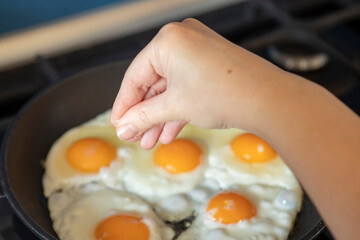 Close-up shot of a woman preparing scrambled eggs for breakfast	