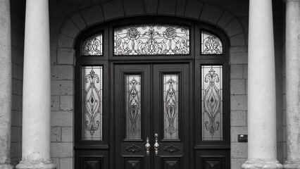 Historic Victorian front door with stained glass panels brass doorknob and ornate stonework