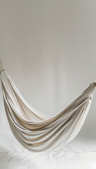 White comfortable hammock set against a light pastel grey background, offering a serene and peaceful