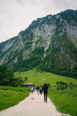 Konigssee Lake in Bavaria Germany with Church by the Lake White Boat Forested Mountain and Beautiful Sunny Trekking in Berchtesgaden German Alps. High quality photo