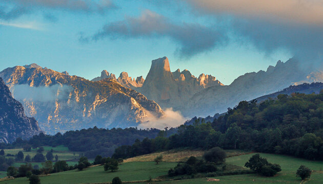 Naranjo de Bulnes on the background and green meadows.