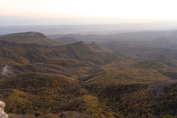Fototapeta premium Autumn mountain forest at sunset - photo wallpaper background, georgia