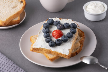 Sandwich with cream cheese, blueberries and strawberries