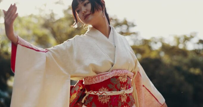 Woman, Japan and dance outdoor in kimono for culture, history and traditional performance with elegance. Female person, moving and spiritual dancer in nature for heritage, art and garden as Japanese