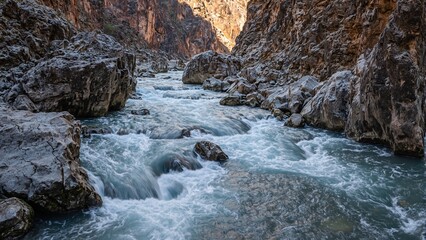 Serene river flowing through rugged canyon landscape