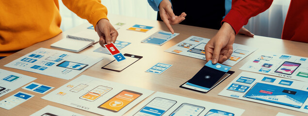 Panorama banner of startup company employee planning on user interface prototype for mobile application or website in office. UX UI designer brainstorm user friendly interface plan. Synergic