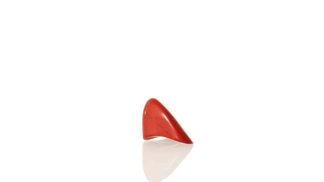 mineral stone red jasper rotates in a circle on a white background