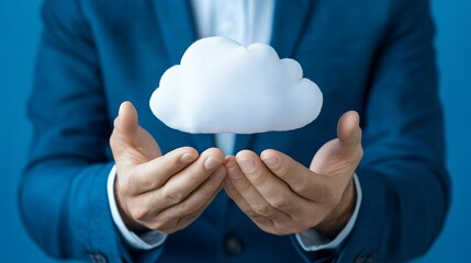 Businessman holding a cloud symbol in his hands, representing cloud computing, data storage, or online services.