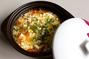 A homemade delicious egg soup meal in the claypot. Made with eggs and chopped tomatoes, it's perfect for lunch.