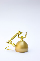 Vintage Golden Telephone with Rotary Dial: This elegant image showcases a vintage-style golden telephone featuring a rotary dial. The polished finish and intricate details make it an ideal prop for h