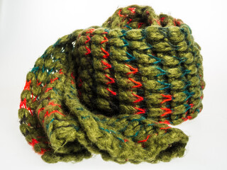 Close-up of a bright green knitted wool scarf. Detailed texture and rich color highlight the quality and comfort of this stylish