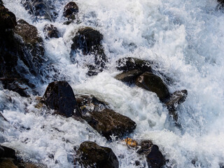 A mountain river with a rapid flow: a mesmerizing stream of water, framed by picturesque mountain...