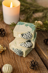 Natural handmade soap with coniferous aroma. Christmas gift. Soap with the shape of pine cones on wooden background