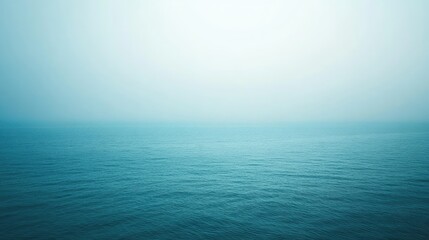 Fototapeta premium Tranquil Seascape with Soft Fog and Gentle Waves, Serene Ocean Horizon Evoking Calmness and Peacefulness in Blue and Aqua Tones for Wellness and Relaxation